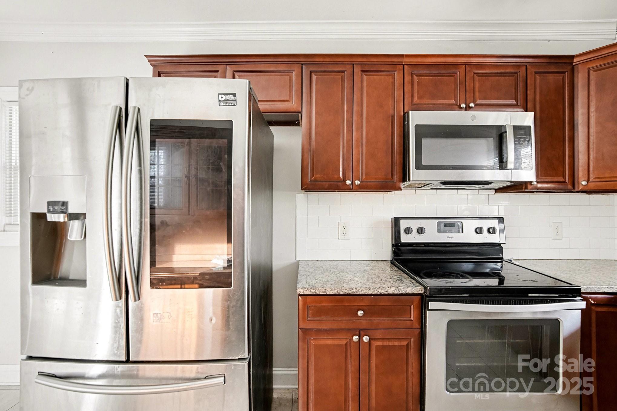 406 South Catawba Street Lancaster, SC 29720 - Photo 21 of 35 a kitchen with stainless steel appliances granite countertop a refrigerator stove and microwave
