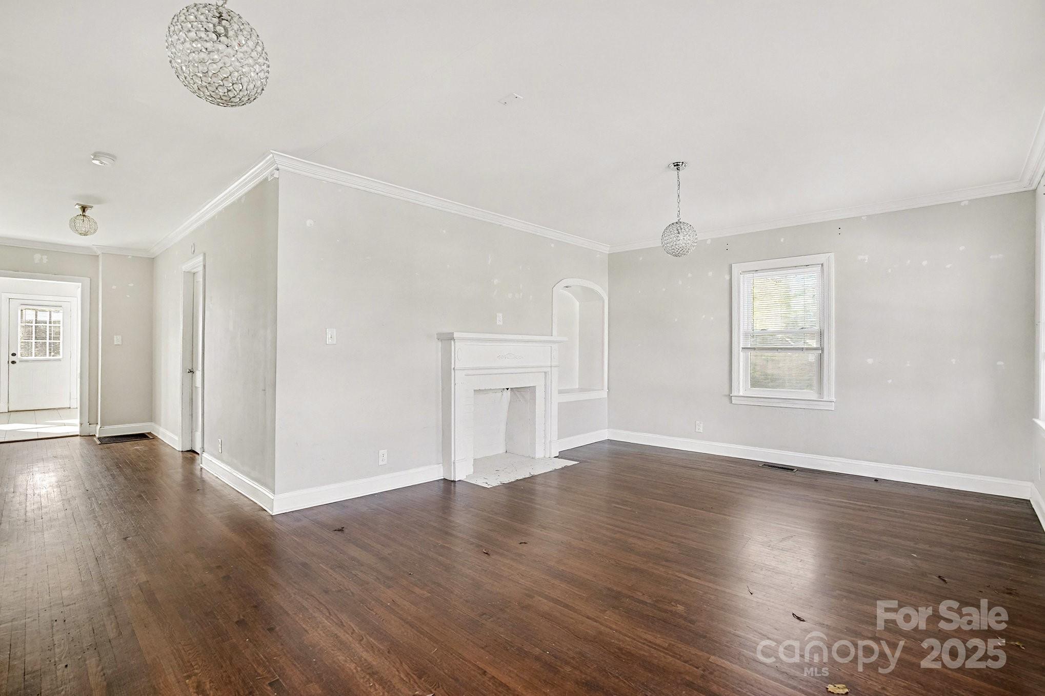 406 South Catawba Street Lancaster, SC 29720 - Photo 9 of 35 an empty room with wooden floor cabinet and windows
