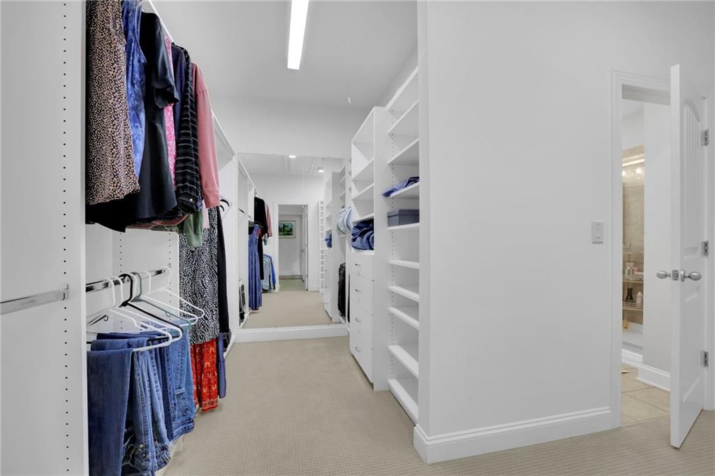 6255 Allison Road Cumming, GA 30040 - Photo 23 of 36 a view of walk in closet with clothes and shoes