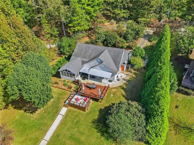 an aerial view of a house with a yard