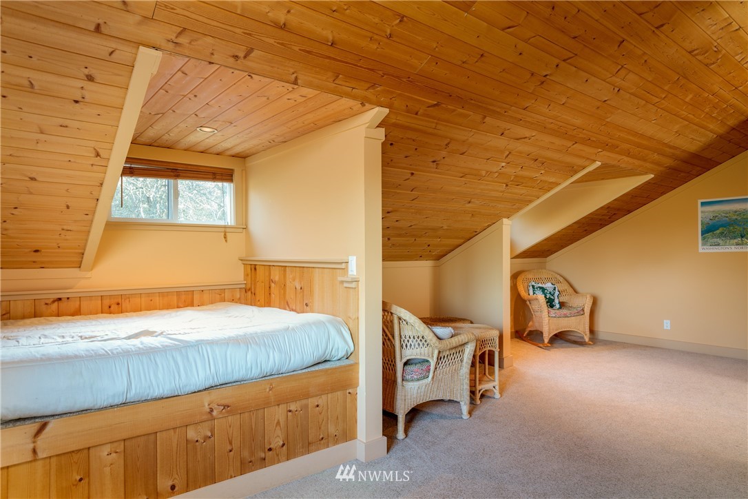 1108 Lopez Sound Road Lopez Island, WA 98261 - Photo 13 of 18 a bedroom with a bed and cabinets