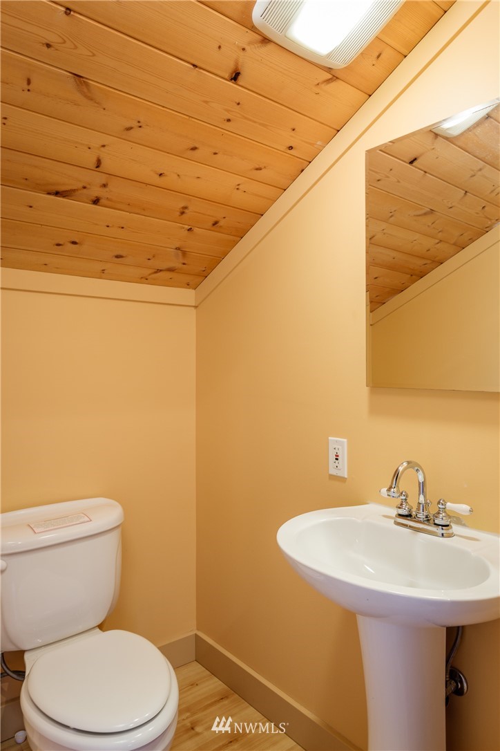 1108 Lopez Sound Road Lopez Island, WA 98261 - Photo 14 of 18 a bathroom with a sink a toilet and mirror