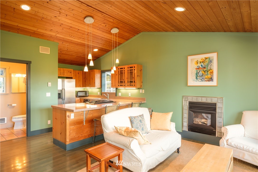 1108 Lopez Sound Road Lopez Island, WA 98261 - Photo 3 of 18 a living room with a couch and a fireplace
