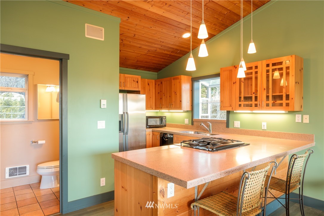 1108 Lopez Sound Road Lopez Island, WA 98261 - Photo 4 of 18 a kitchen with a table and chairs in it