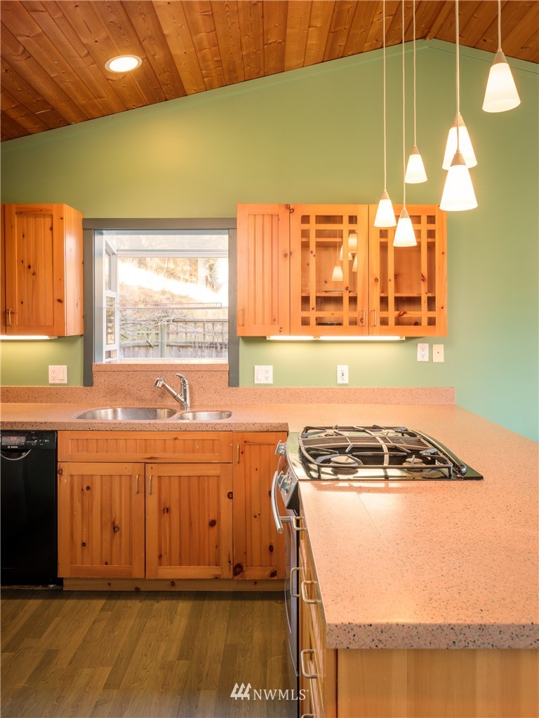 1108 Lopez Sound Road Lopez Island, WA 98261 - Photo 7 of 18 a kitchen with a stove a sink and a microwave