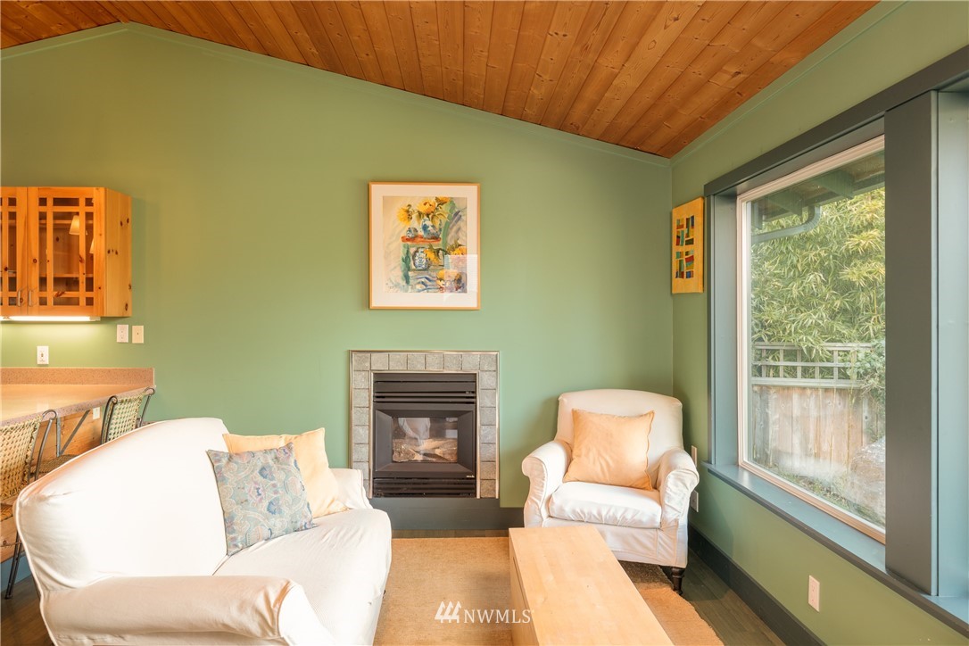 1108 Lopez Sound Road Lopez Island, WA 98261 - Photo 8 of 18 a living room with furniture and a fireplace