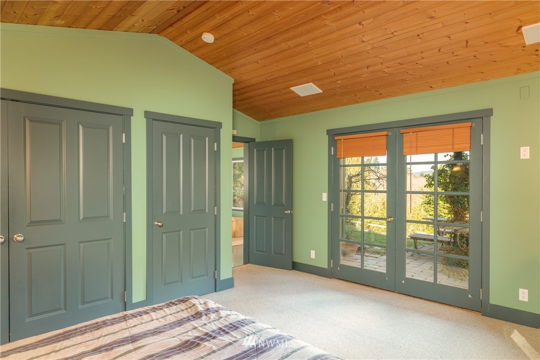 1108 Lopez Sound Road Lopez Island, WA 98261 - Photo 9 of 18 a bedroom with a bed and a window