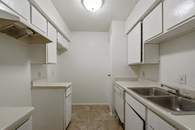 a kitchen with a sink and cabinets