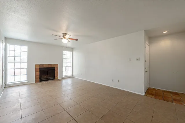 a view of a livingroom with a fireplace and window