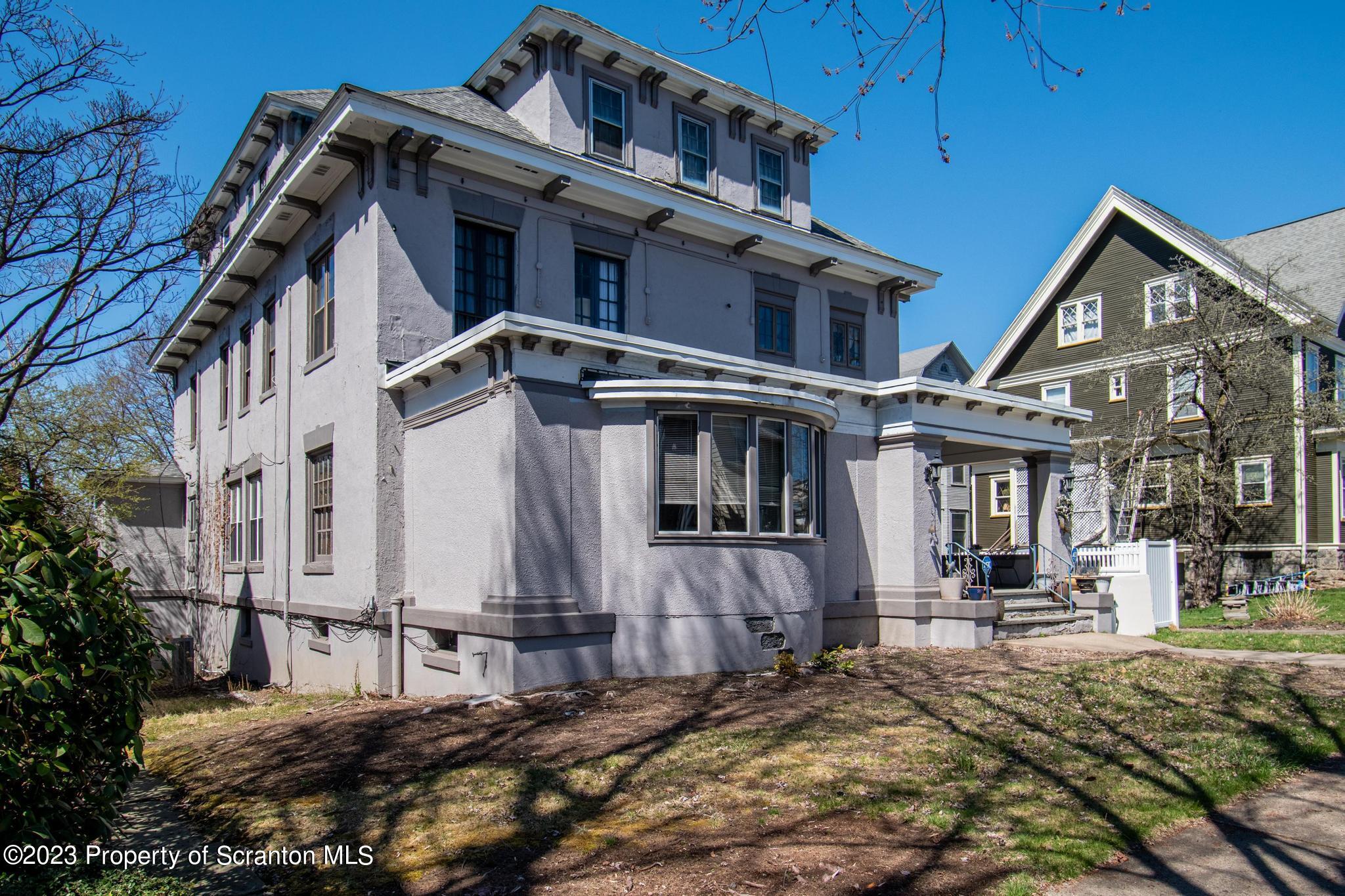 835 North Webster Avenue Scranton, PA 18510 - Photo 3 of 43 a view of a white house with large windows and wooden fence