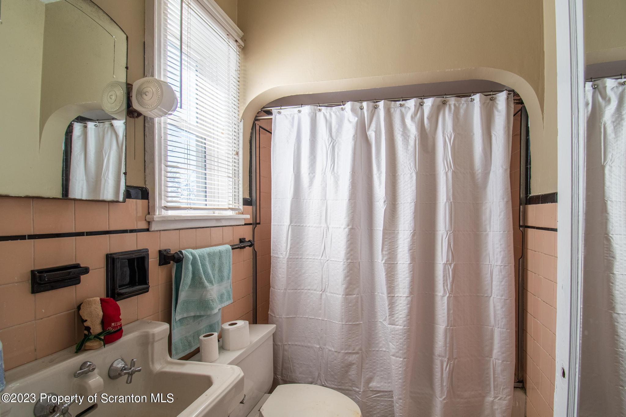 835 North Webster Avenue Scranton, PA 18510 - Photo 38 of 43 a bathroom with a sink a toilet and a mirror