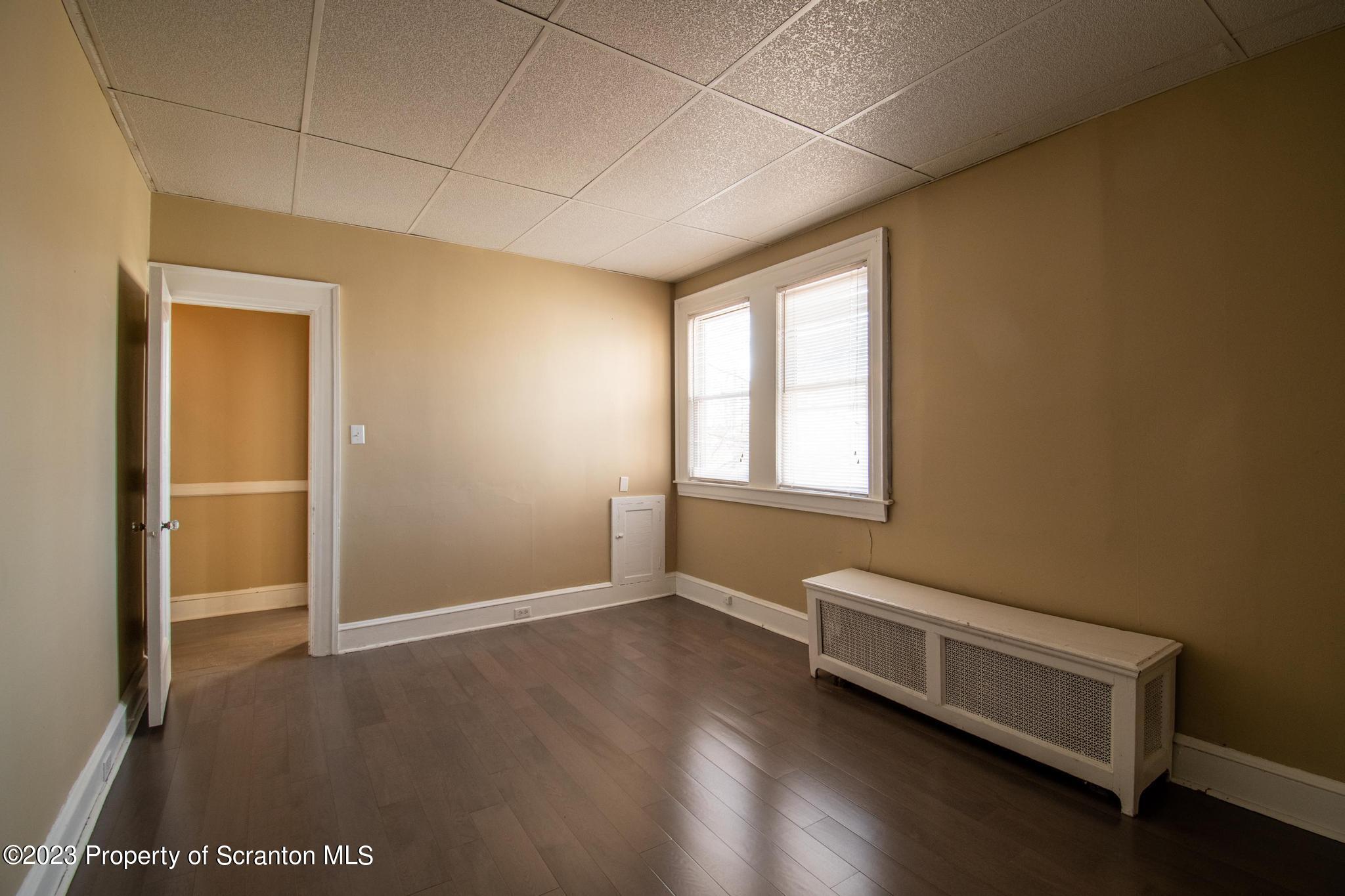 835 North Webster Avenue Scranton, PA 18510 - Photo 40 of 43 an empty room with wooden floor and windows