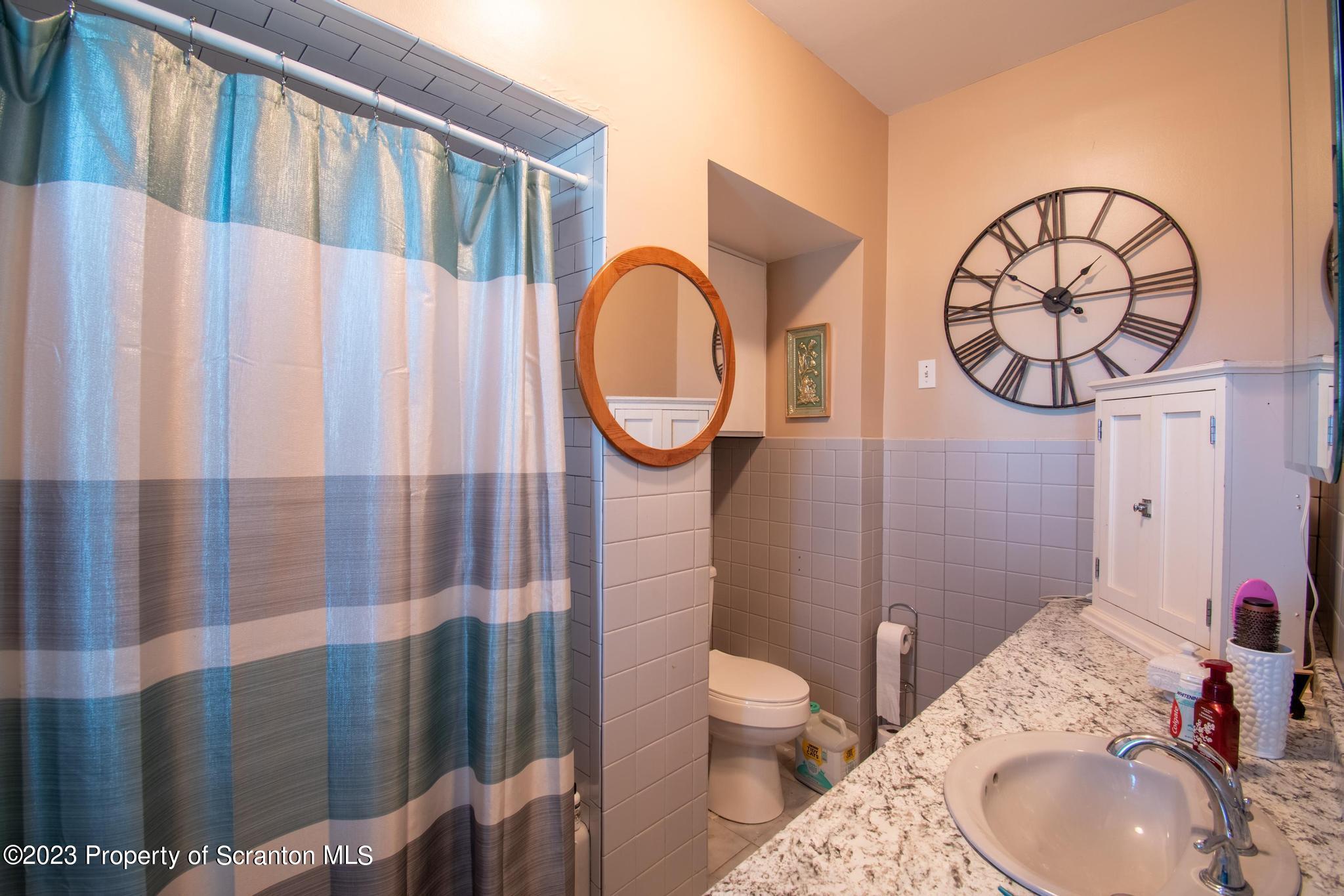 835 North Webster Avenue Scranton, PA 18510 - Photo 4 of 43 a bathroom with a toilet a sink and a mirror