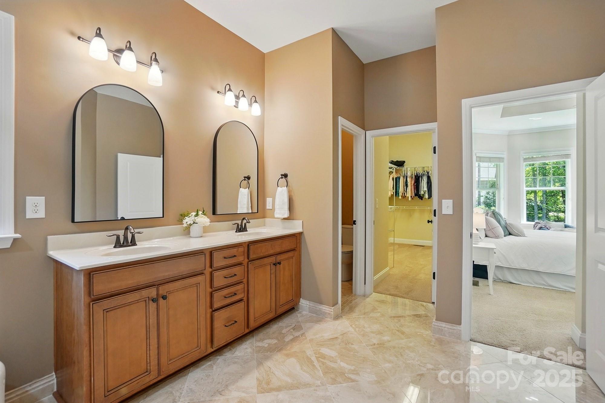 404 Brookridge Drive Mount Holly, NC 28120 - Photo 19 of 44 a spacious bathroom with a double vanity sink and a mirror