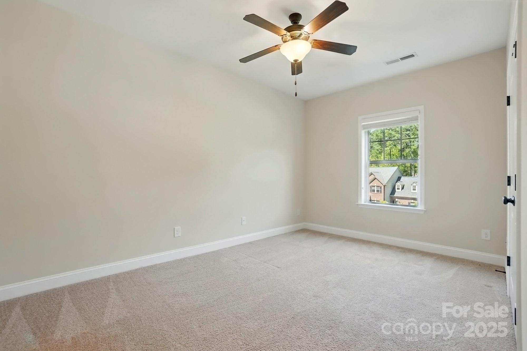 404 Brookridge Drive Mount Holly, NC 28120 - Photo 25 of 44 an empty room with a window and a fan