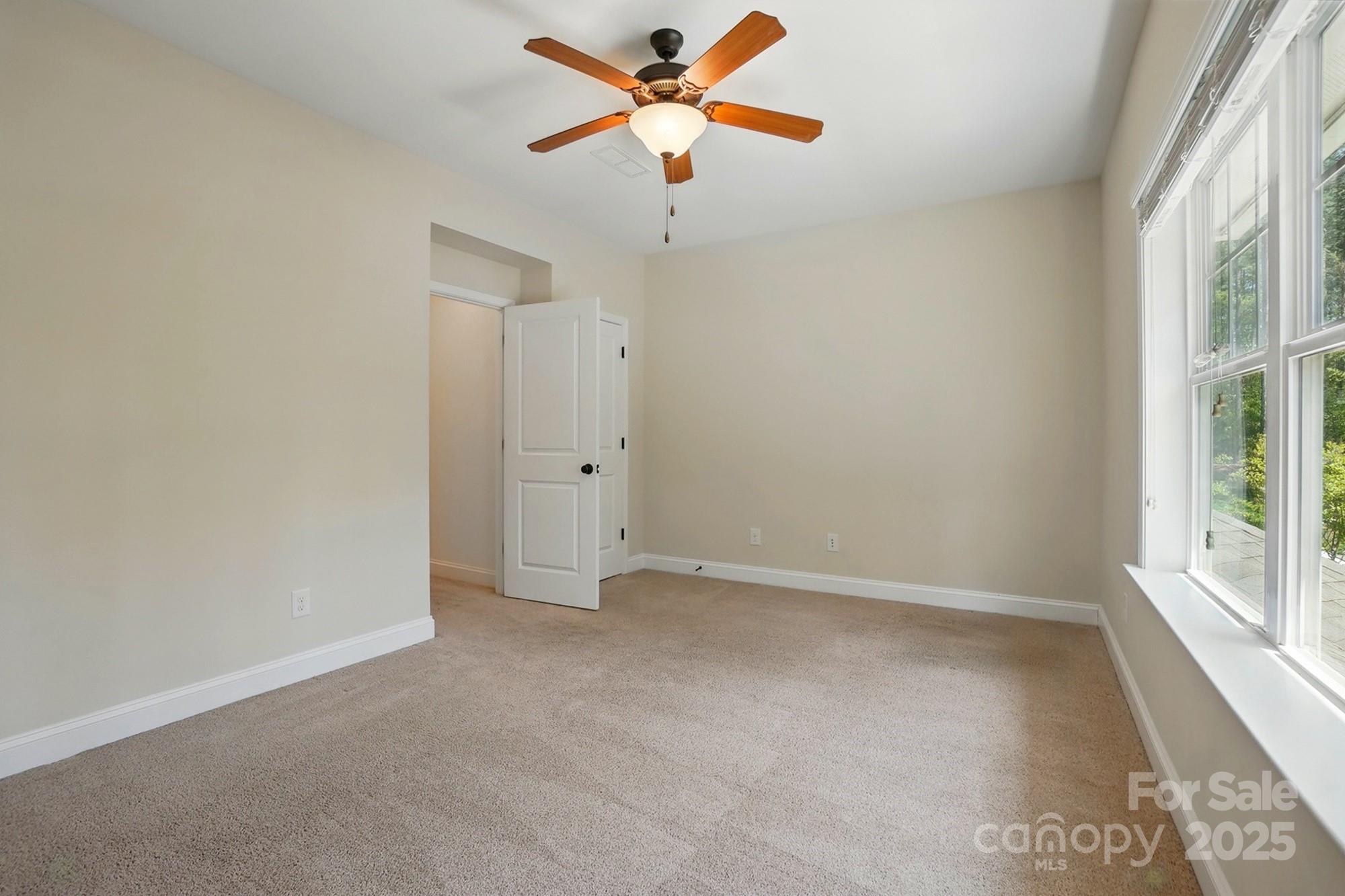 404 Brookridge Drive Mount Holly, NC 28120 - Photo 28 of 44 an empty room with a window and a fan