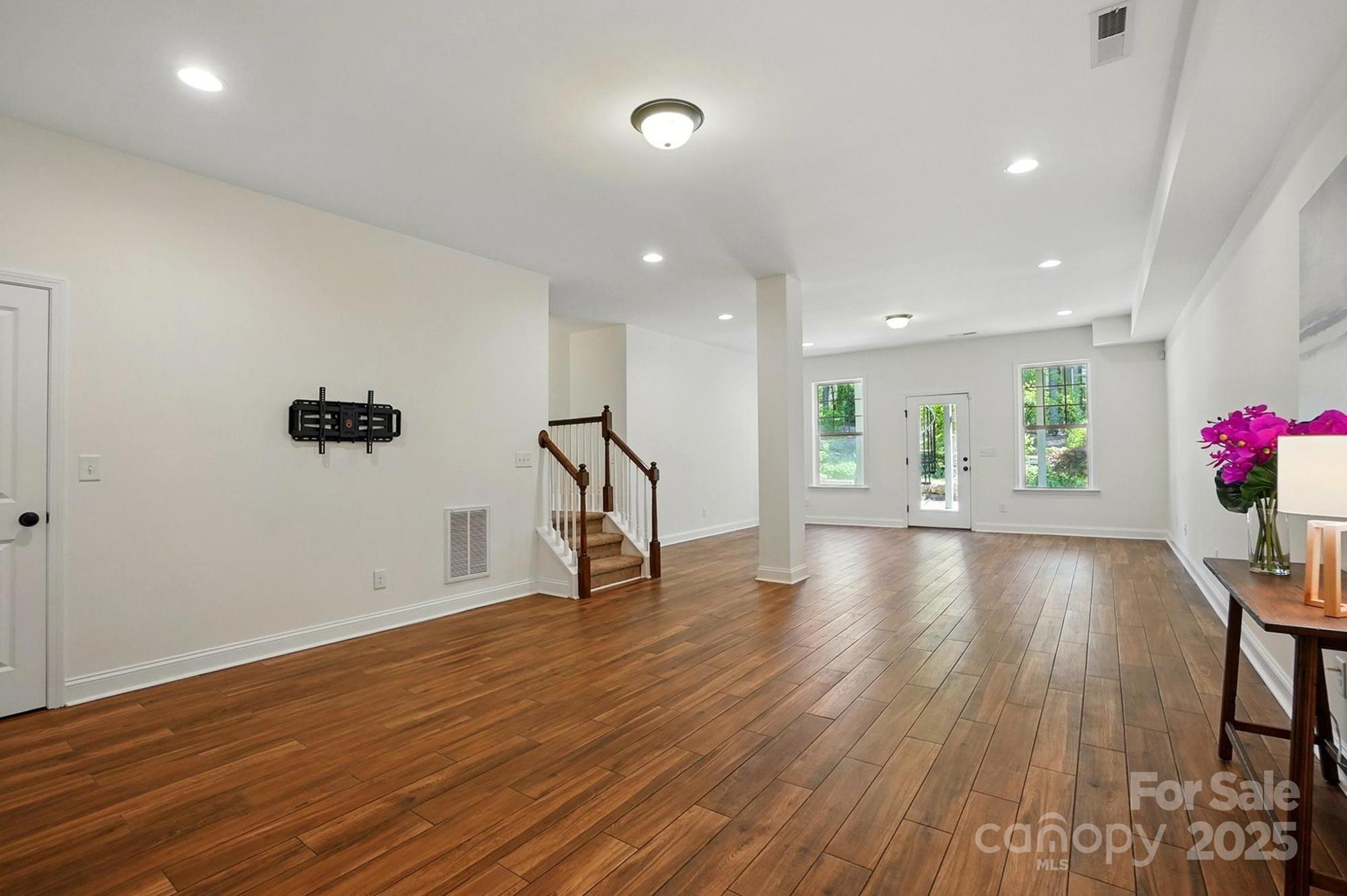 404 Brookridge Drive Mount Holly, NC 28120 - Photo 29 of 44 a view of an empty room with wooden floor and a potted plant