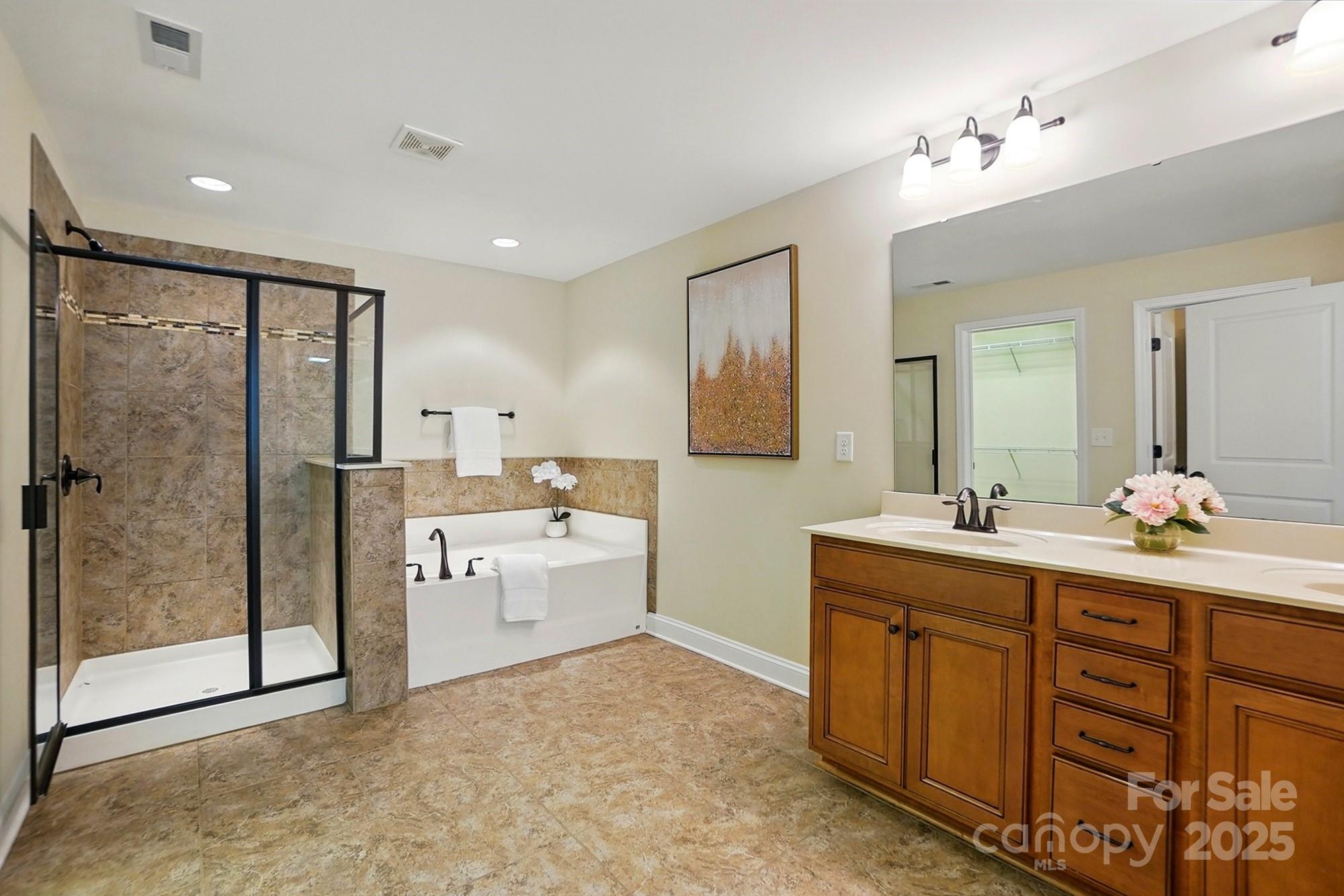 404 Brookridge Drive Mount Holly, NC 28120 - Photo 31 of 44 a bathroom with a double vanity sink mirror and shower