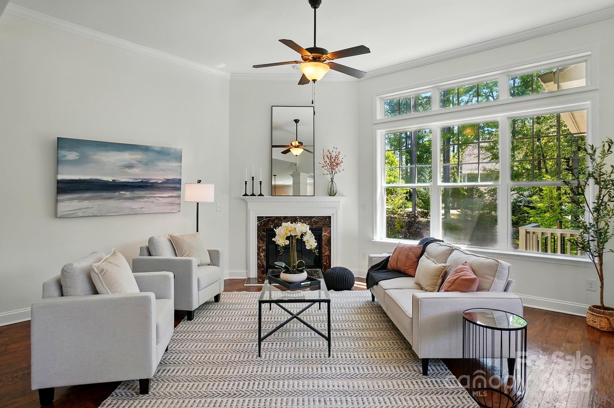 404 Brookridge Drive Mount Holly, NC 28120 - Photo 5 of 44 a living room with furniture a fireplace and a large window