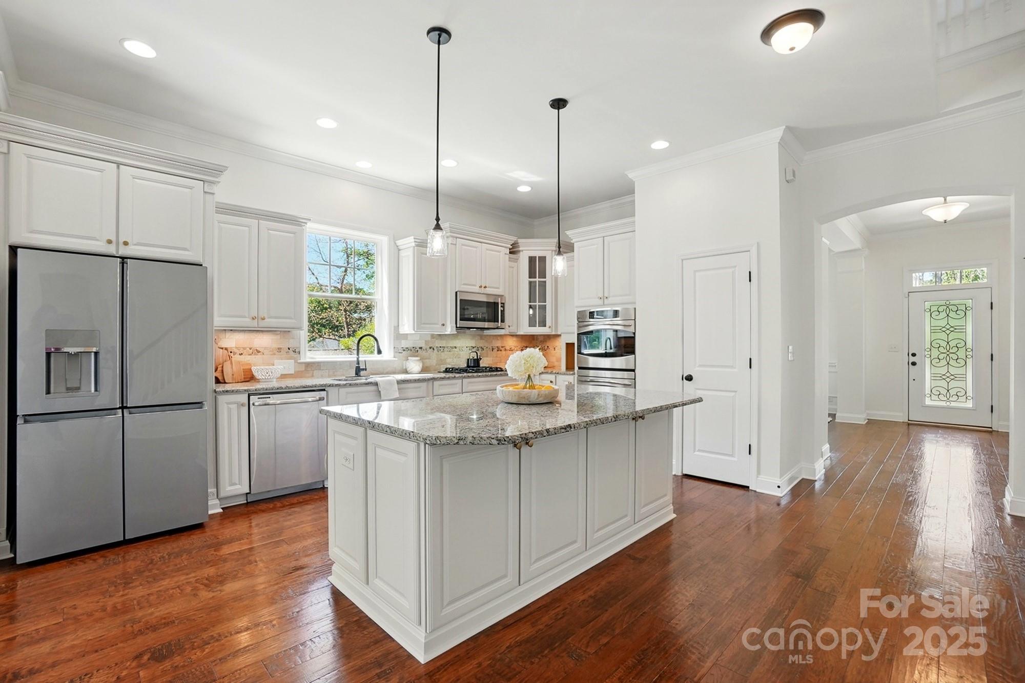 404 Brookridge Drive Mount Holly, NC 28120 - Photo 8 of 44 a kitchen with stainless steel appliances granite countertop a sink a stove a refrigerator and a oven with wooden floor