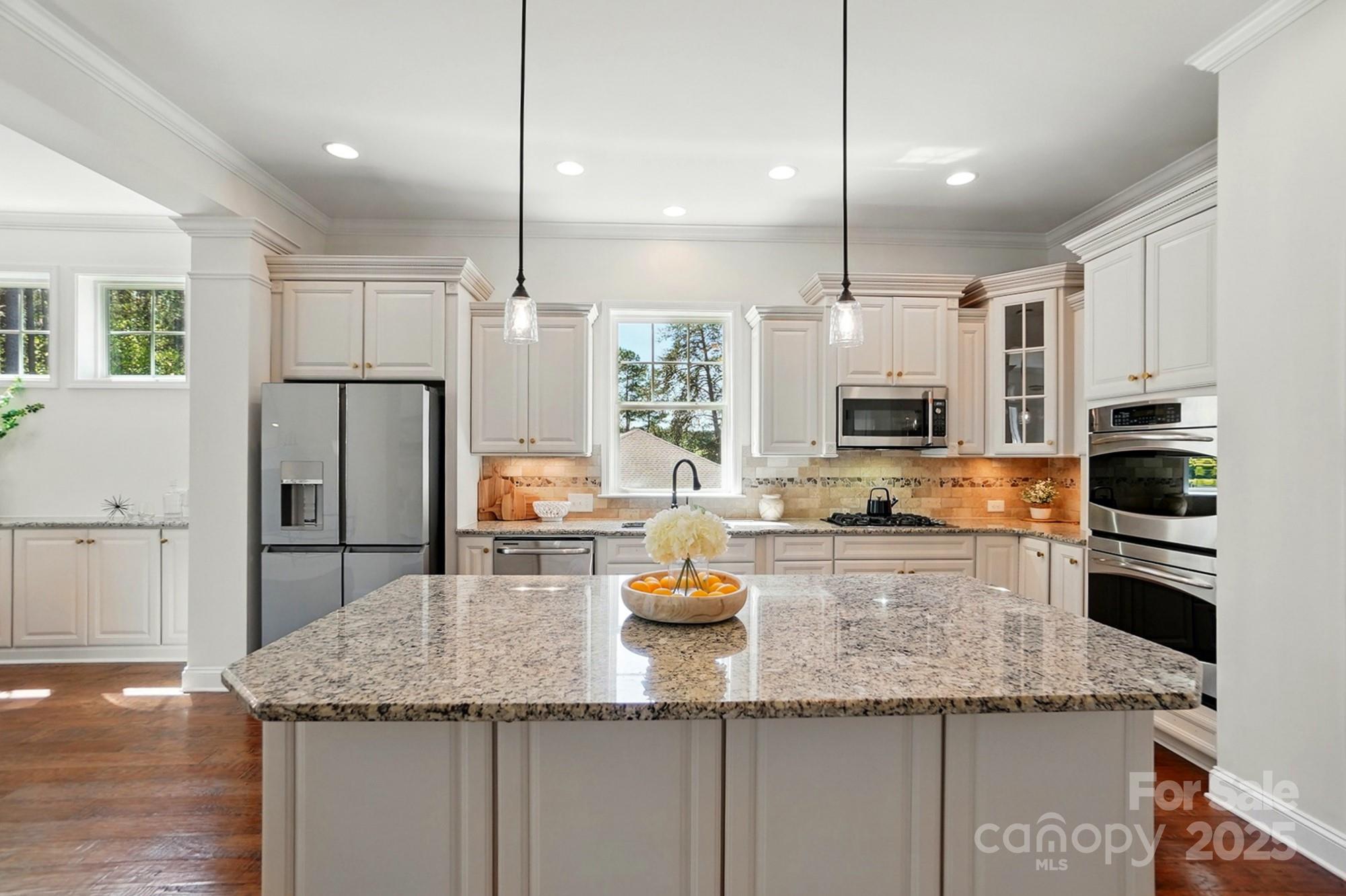 404 Brookridge Drive Mount Holly, NC 28120 - Photo 9 of 44 a kitchen with stainless steel appliances granite countertop a sink refrigerator and microwave