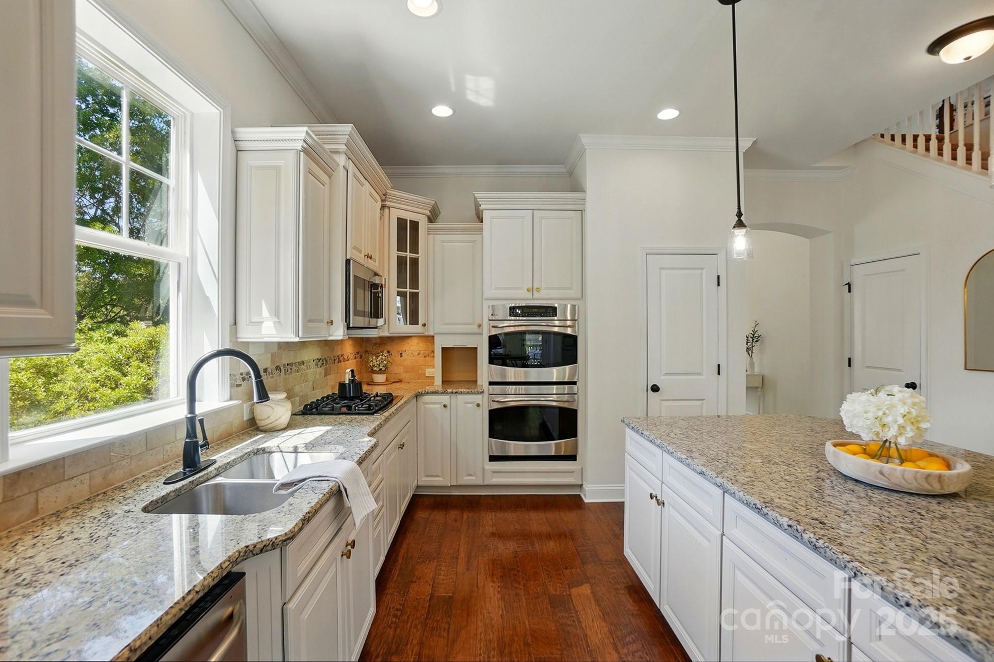 404 Brookridge Drive Mount Holly, NC 28120 - Photo 10 of 44 a kitchen with granite countertop a sink a counter space appliances and windows