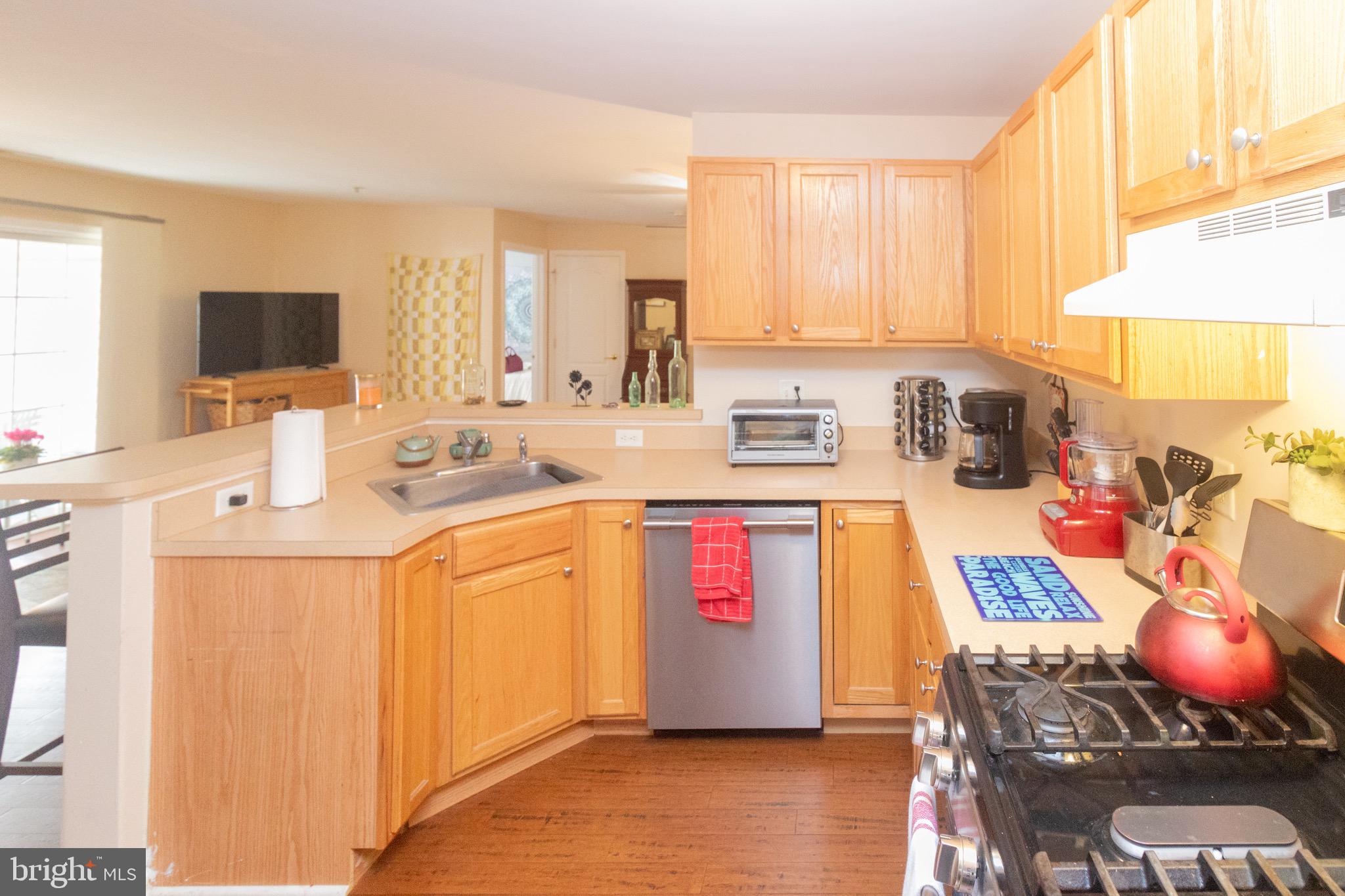 219 Lawrence Lane Riverside, NJ 08075 - Photo 9 of 23 a kitchen with a stove a sink and a microwave