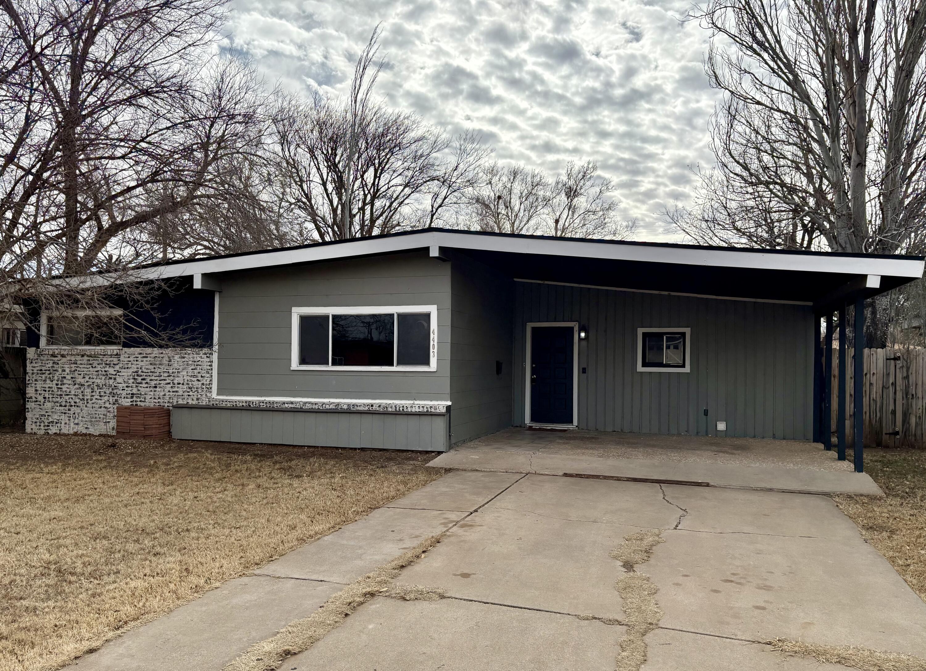 4403 44th Street Lubbock, TX 79414 - Photo 1 of 25 a house with trees in the background