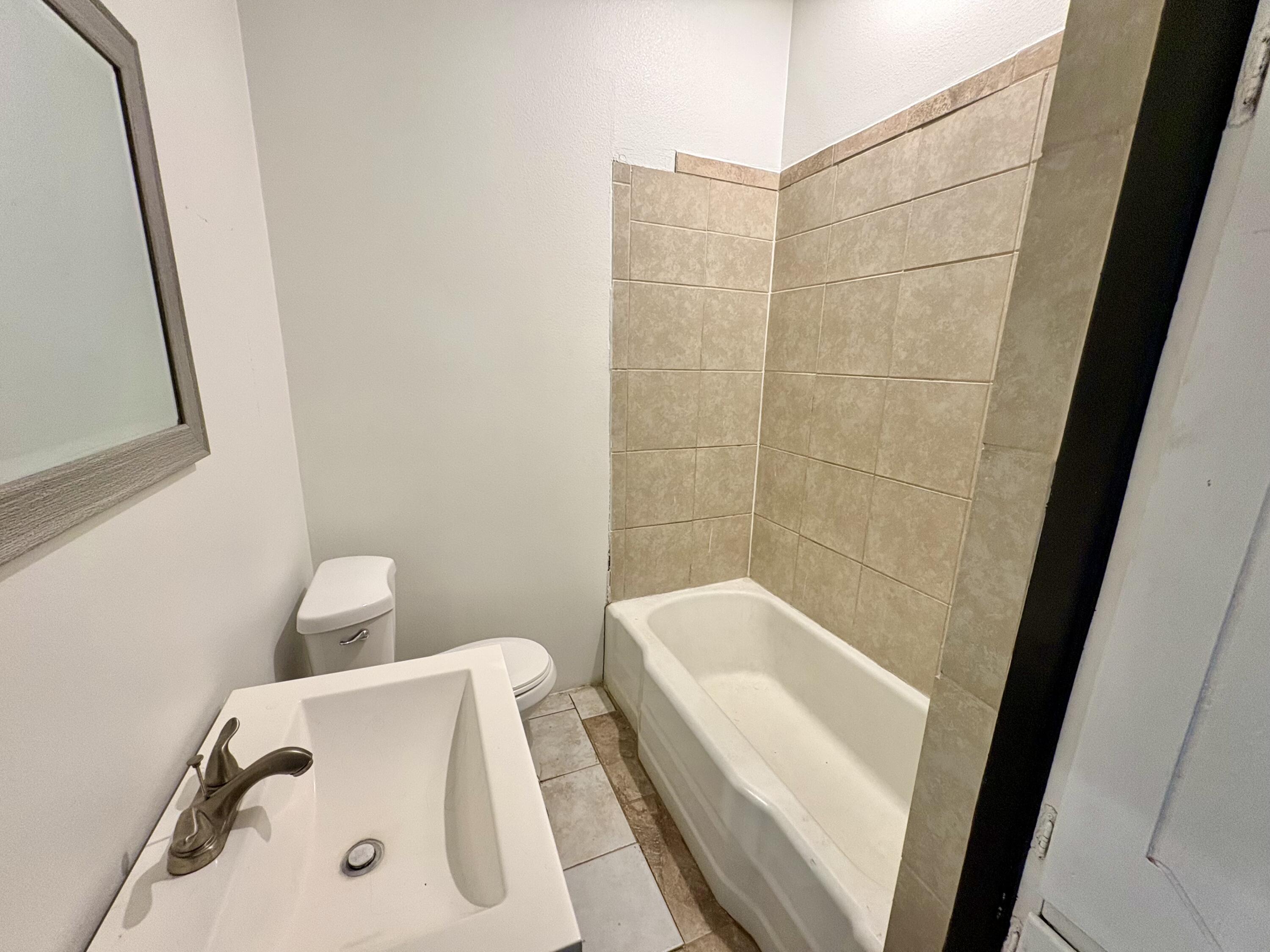 4403 44th Street Lubbock, TX 79414 - Photo 15 of 25 a bathroom with a tub and sink