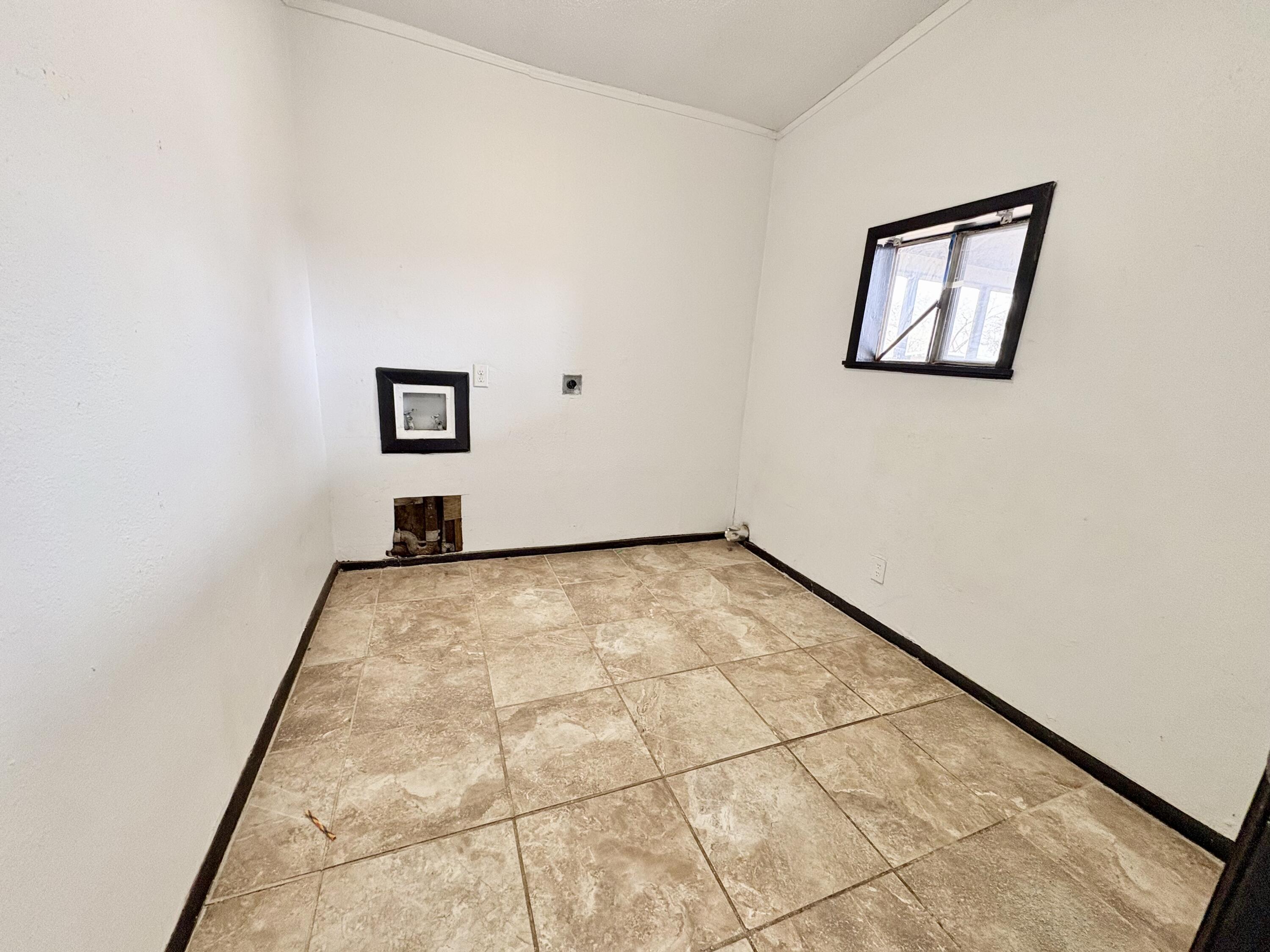 4403 44th Street Lubbock, TX 79414 - Photo 19 of 25 a view of a room with wooden floor and a window