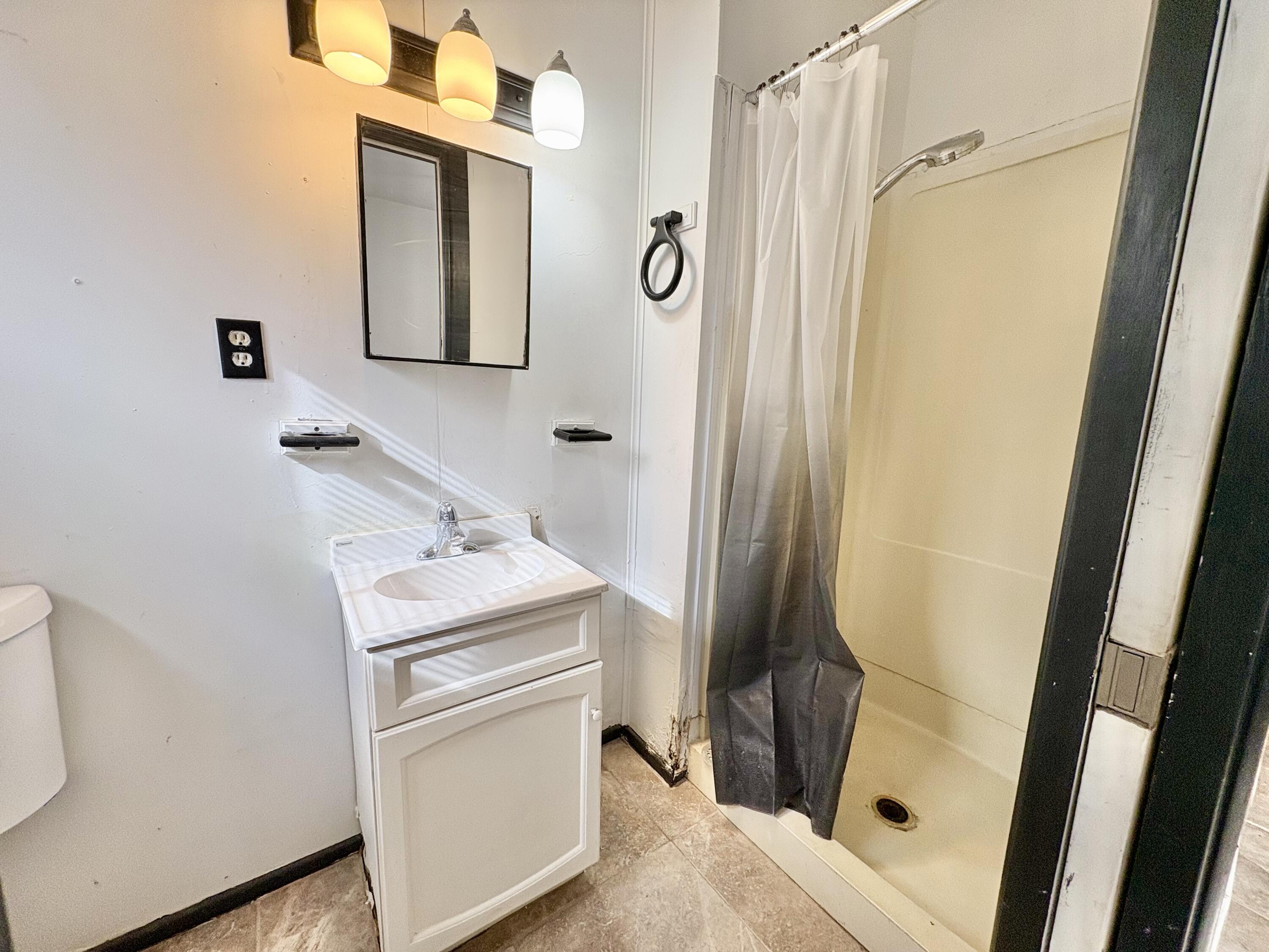 4403 44th Street Lubbock, TX 79414 - Photo 23 of 25 a bathroom with a sink and mirror with toilet