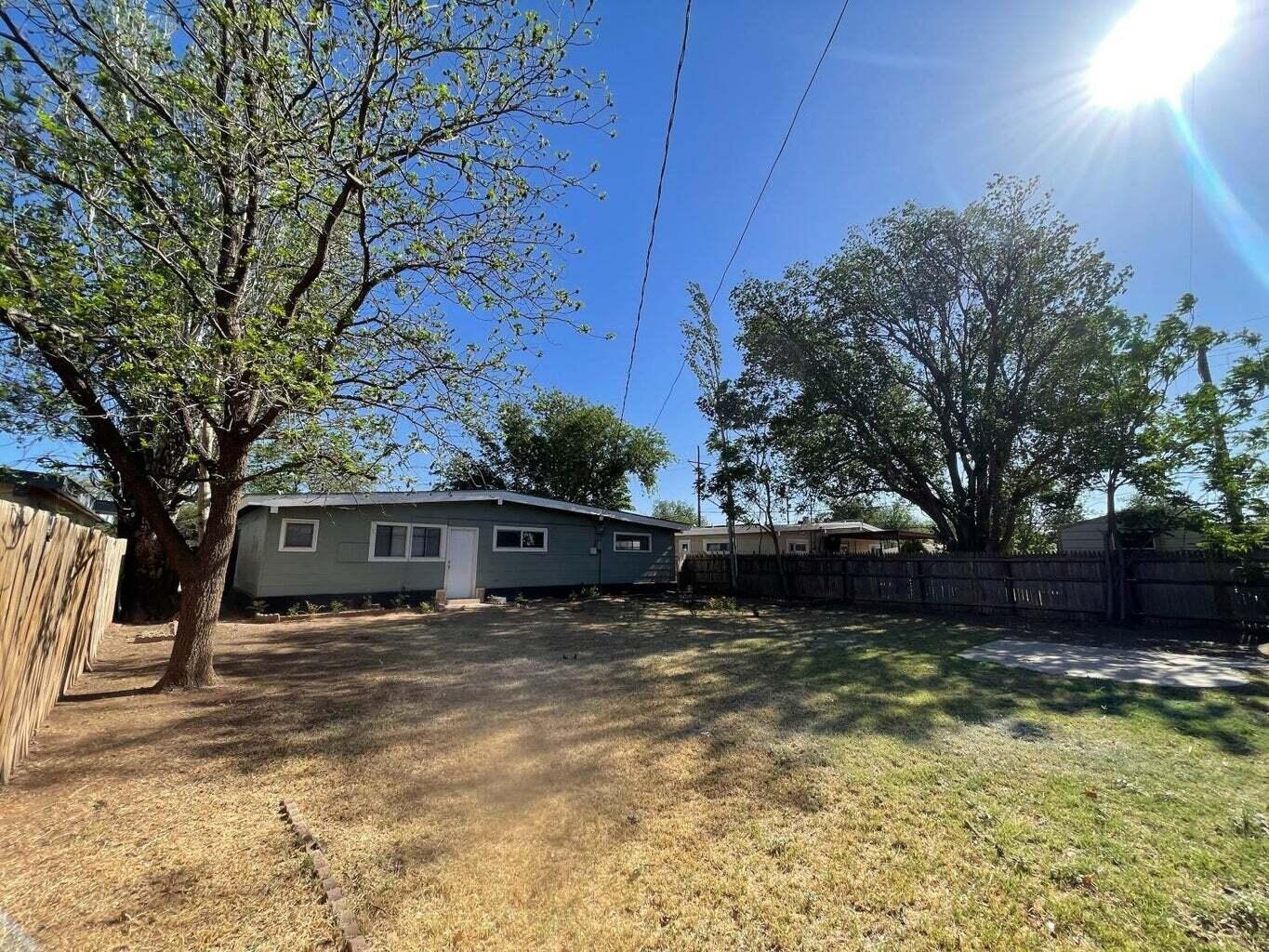 4403 44th Street Lubbock, TX 79414 - Photo 24 of 25 a view of a house with a large tree and a yard