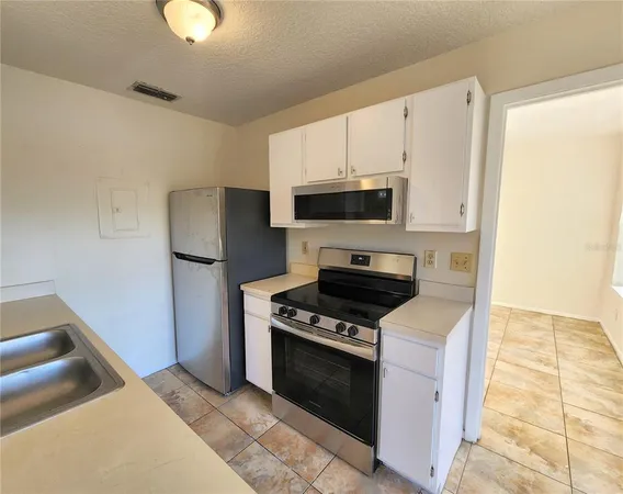 a kitchen with a stove and a refrigerator