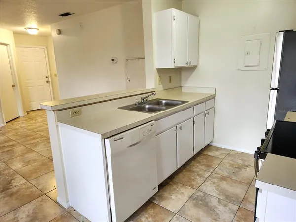 a kitchen with a stove a sink and a refrigerator