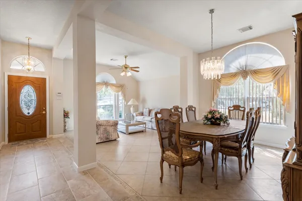 a view of a dining room with furniture and chandelier