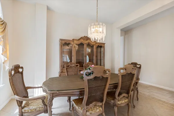 a view of a dining room with furniture and chandelier