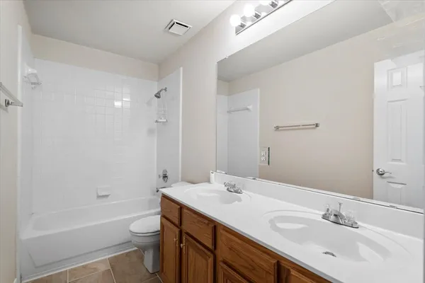 a bathroom with a sink a toilet a shower and a mirror
