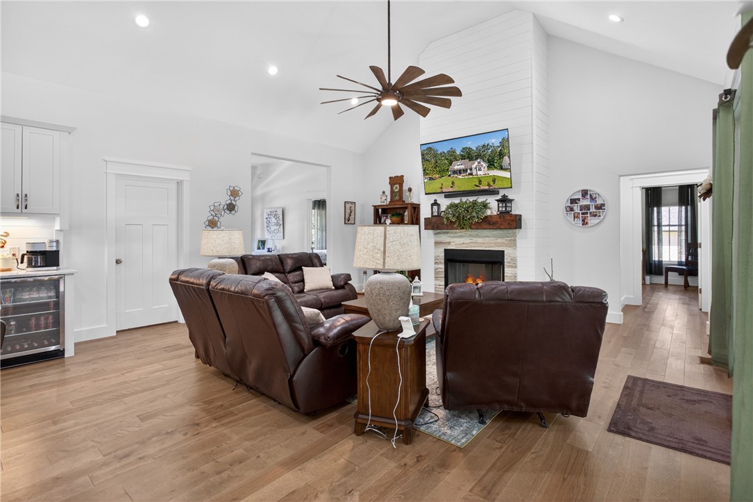 921 Falling Waters Lane Seneca, SC 29672 - Photo 9 of 46 A striking fireplace with a shiplap facade anchors this spacious living area, complete with soaring vaulted ceilings.