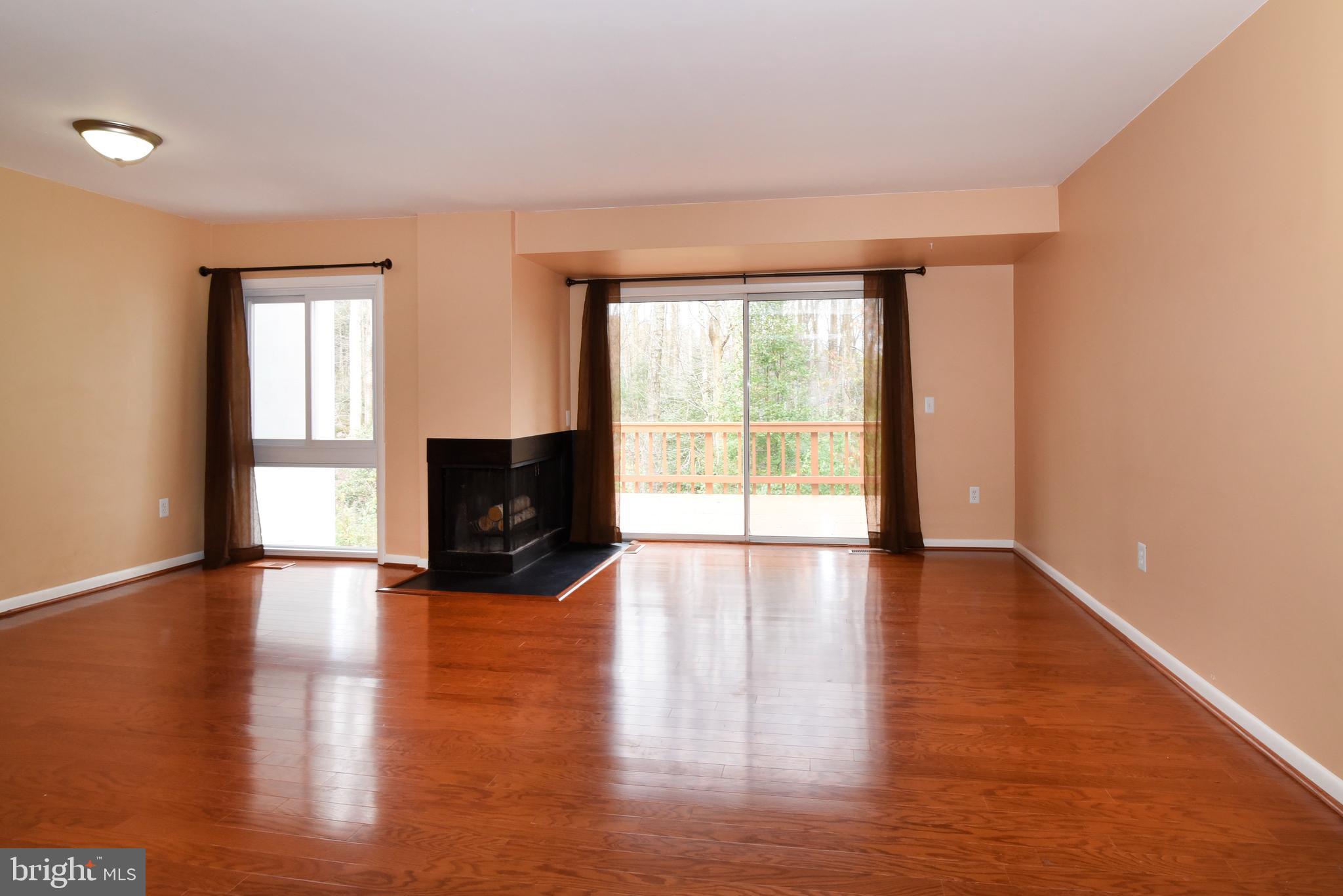 2334 Generation Drive Reston, VA 20191 - Photo 20 of 55 a view of empty room with wooden floor and fireplace