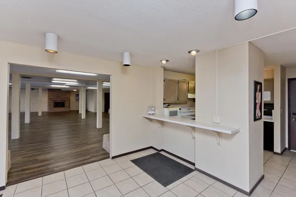 a view of a hallway with dining area and chandelier