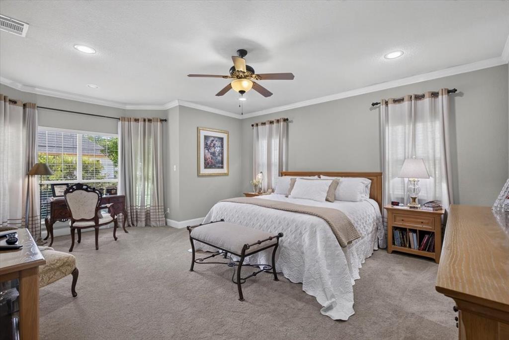 111 Trailwood Road Enchanted Oaks, TX 75156 - Photo 14 of 33 a spacious bedroom with a bed and a chandelier