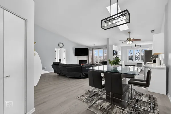 a living room with furniture or chandelier and a wooden floor