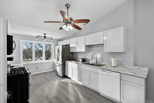 a kitchen with a sink stove and refrigerator