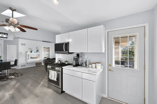 a kitchen with a sink cabinets and window