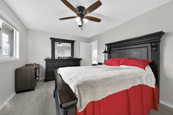 a bedroom with a bed and a dresser