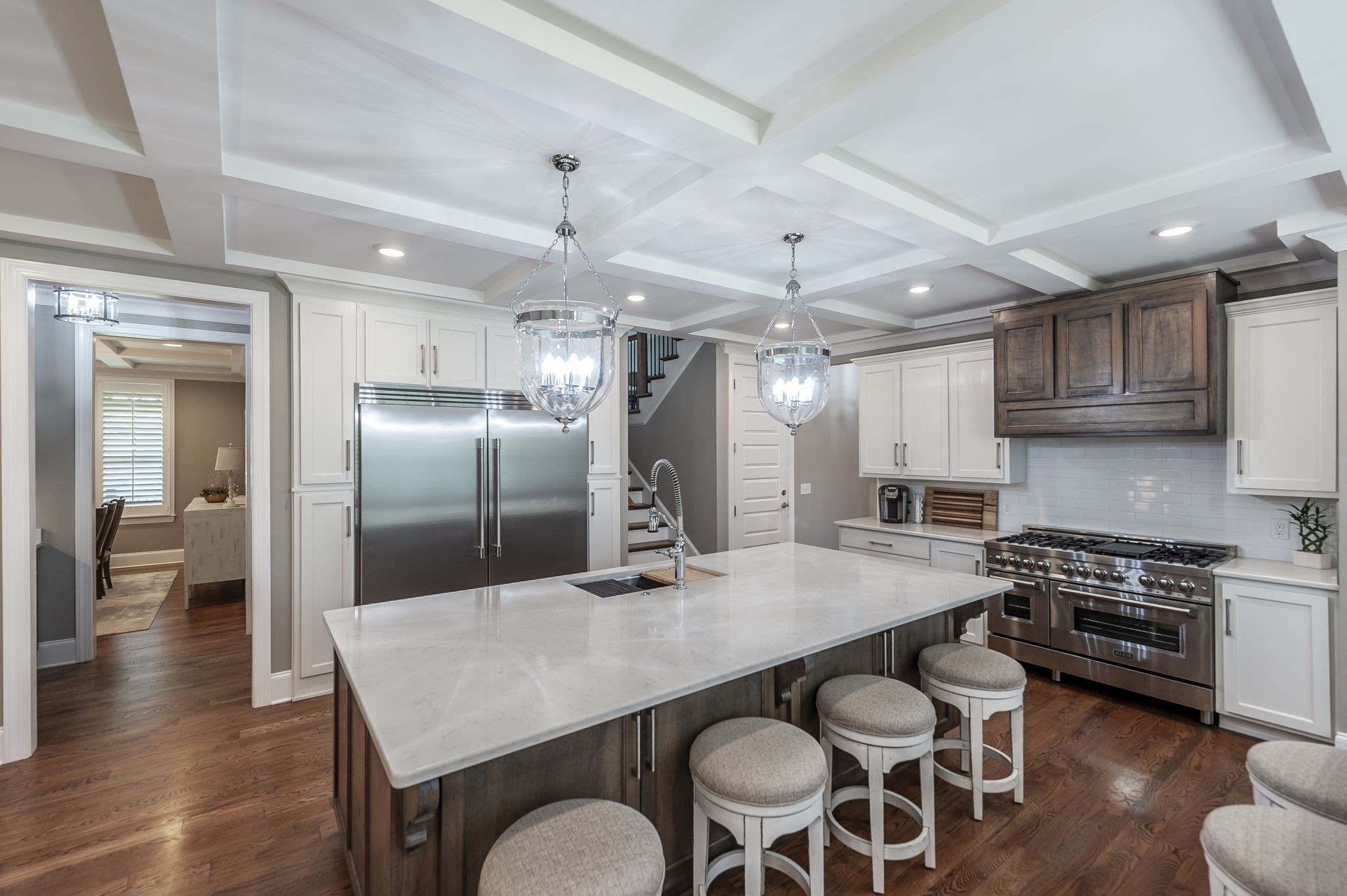 872 Douglas Bend Road Gallatin, TN 37066 - Photo 15 of 80 a kitchen with stainless steel appliances granite countertop a stove a refrigerator a sink a dining table and chairs with wooden floor