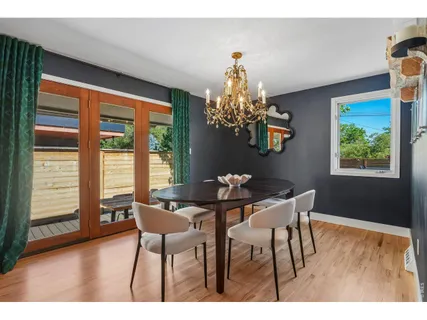 a view of a dining room with furniture wooden floor and chandelier