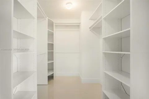 a bathroom with a shower a sink and a mirror