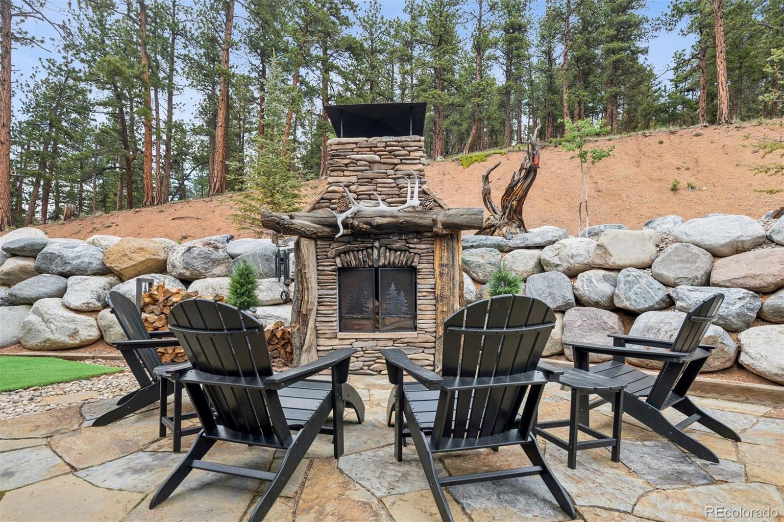 2894 County Road 43 Bailey, CO 80421 - Photo 27 of 40 a view of a chairs and table in the backyard