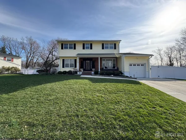 a view of house with a yard